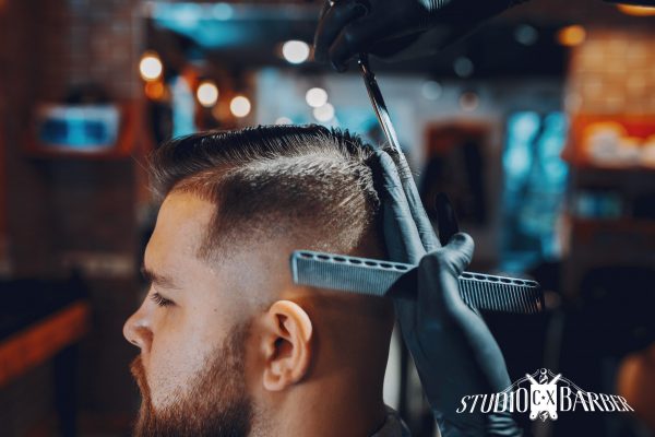 Man with a beard. Hairdresser with a client.